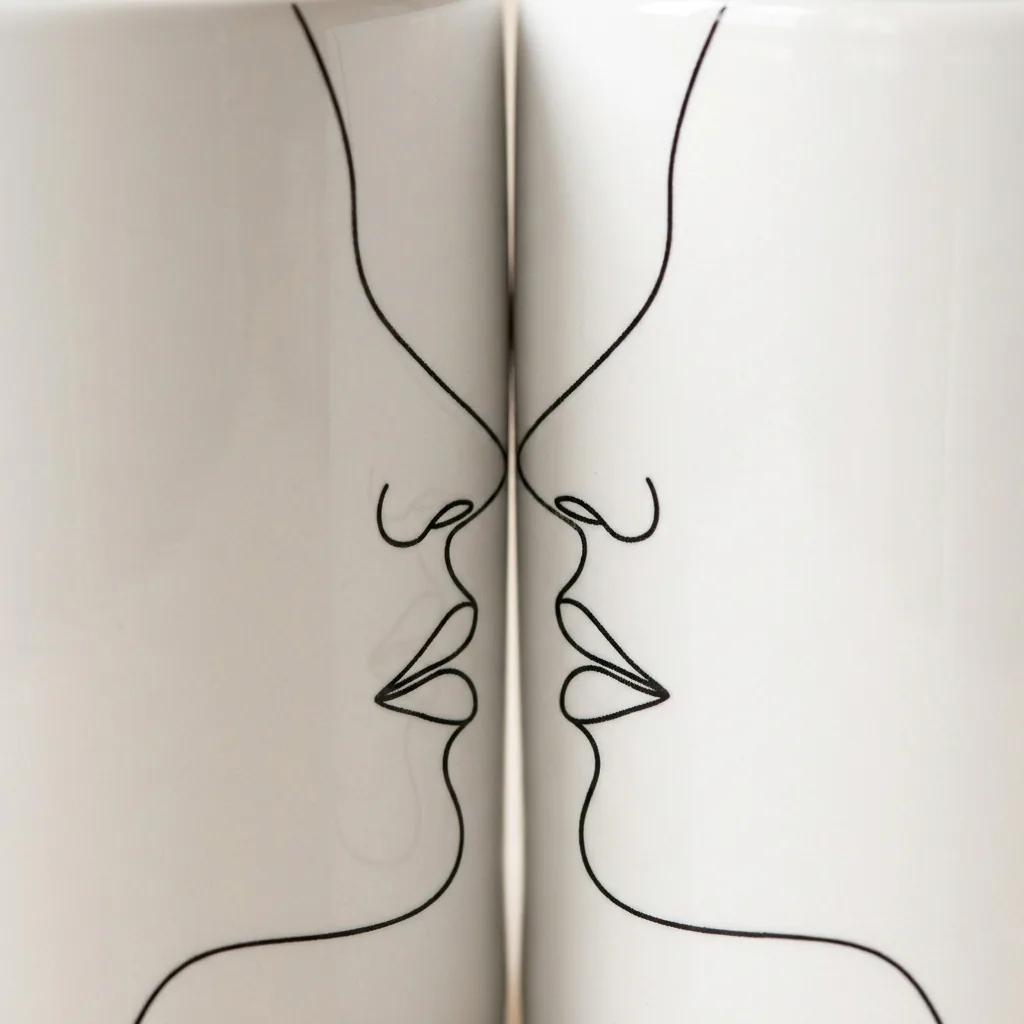 Two Faces Mug Pair, close-up of the line drawing