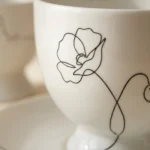 Wild Poppy Tea Cup & Saucer, close-up of the line drawing